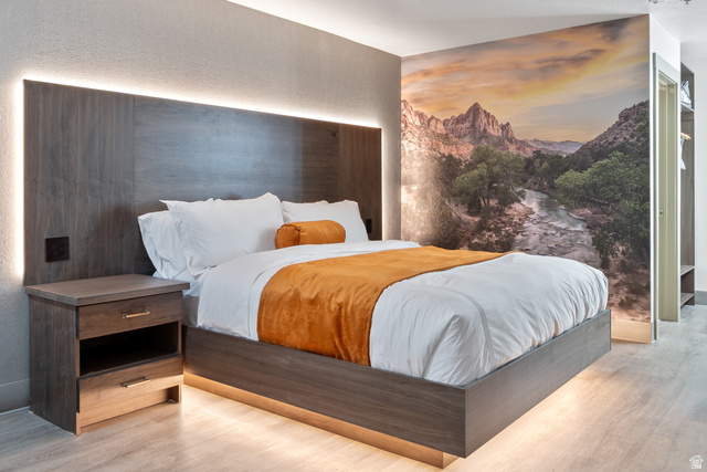 245 Red Cliffs Drive, Unit 104 St. George, UT 84790 - Photo 2 of 33 Bedroom with wood finished floors and a textured wall