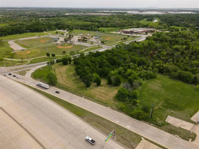 an aerial view of residential houses with outdoor space and river