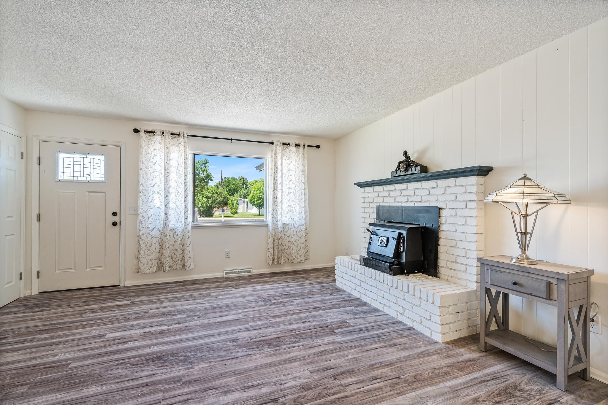 552 Normandy Drive Grand Junction, CO 81501 - Photo 2 of 23 a view of an empty room with wooden floor and fireplace
