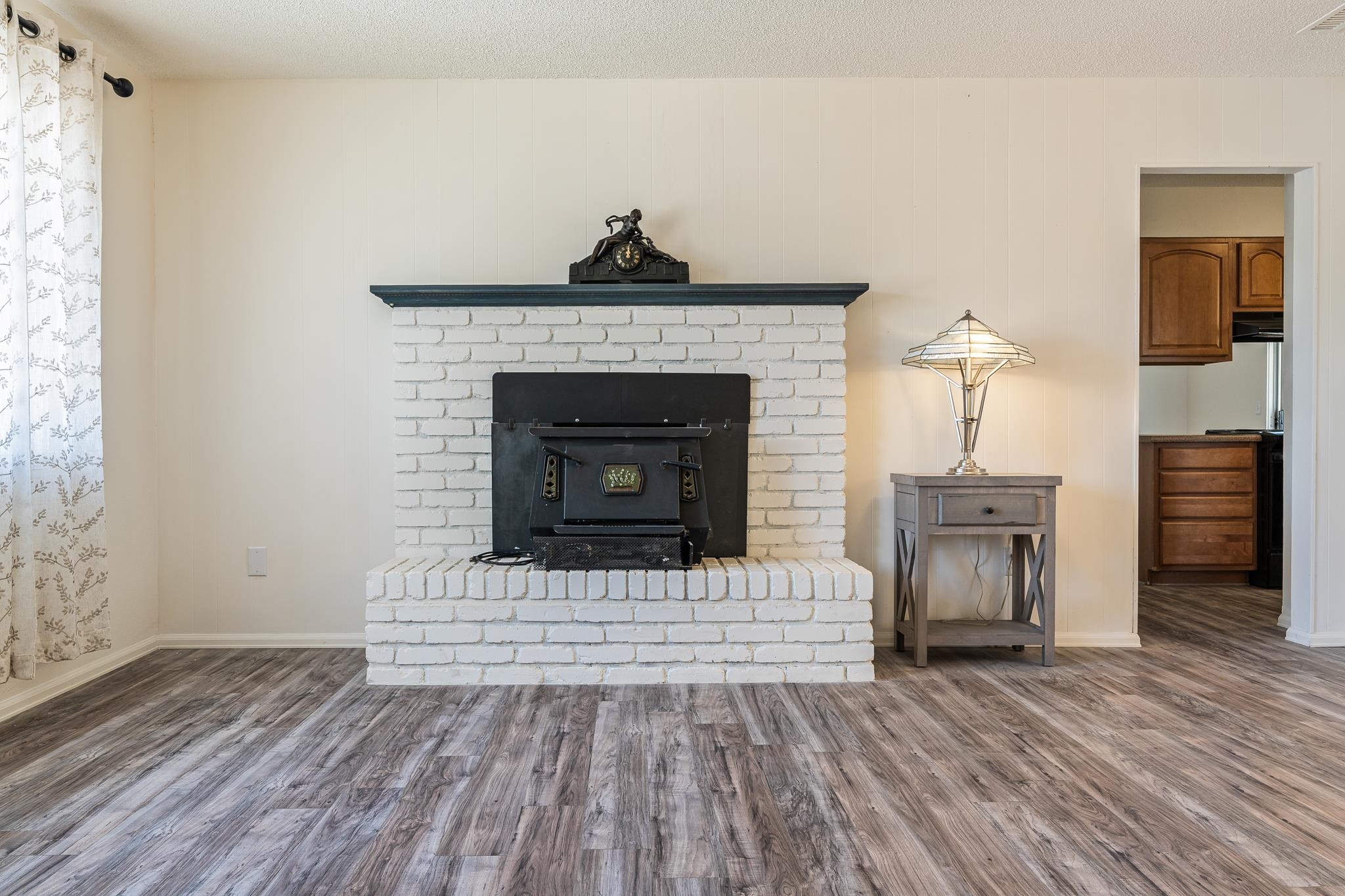 552 Normandy Drive Grand Junction, CO 81501 - Photo 3 of 23 a living room with a fireplace and wooden floor