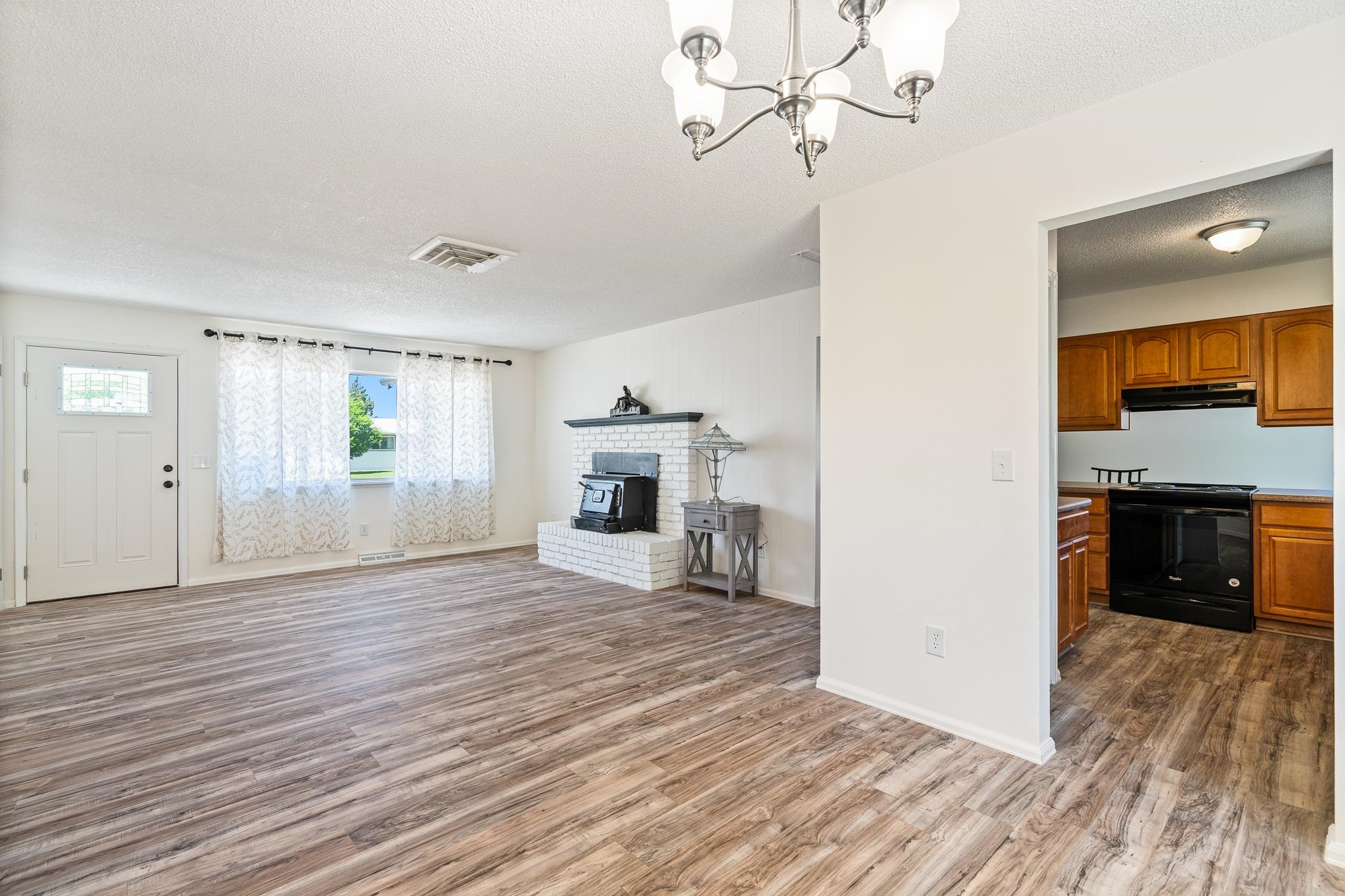 552 Normandy Drive Grand Junction, CO 81501 - Photo 6 of 23 a view of empty room with wooden floor and fireplace