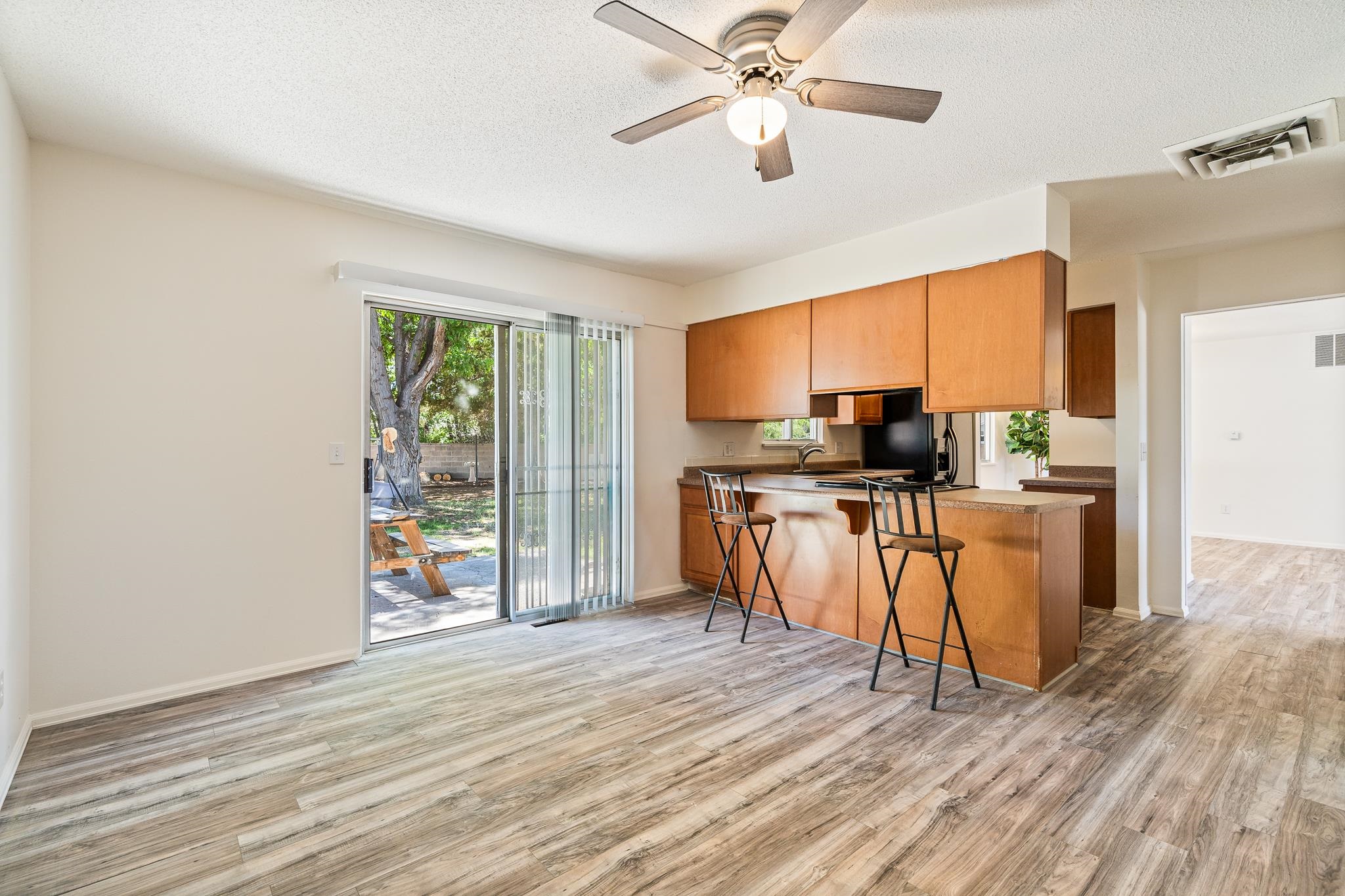 552 Normandy Drive Grand Junction, CO 81501 - Photo 7 of 23 a kitchen with granite countertop a stove top oven a sink dishwasher a dining table and chairs with wooden floor