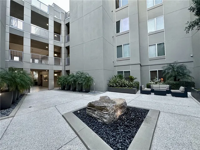 a view of a backyard with plants and outdoor seating
