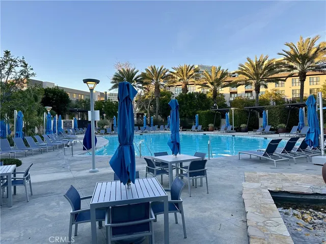 a view of a backyard with a patio and swimming pool