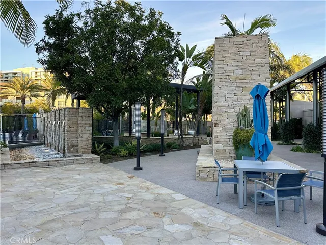 a backyard of a house with table and chairs