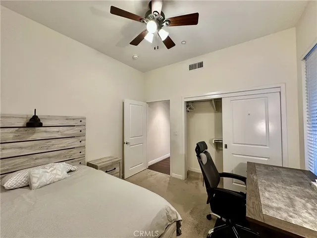 a bedroom with a bed and a desk