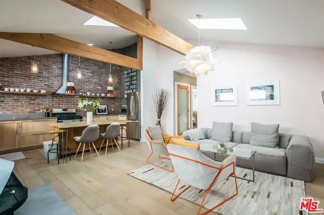 a living room with furniture a large window and a table
