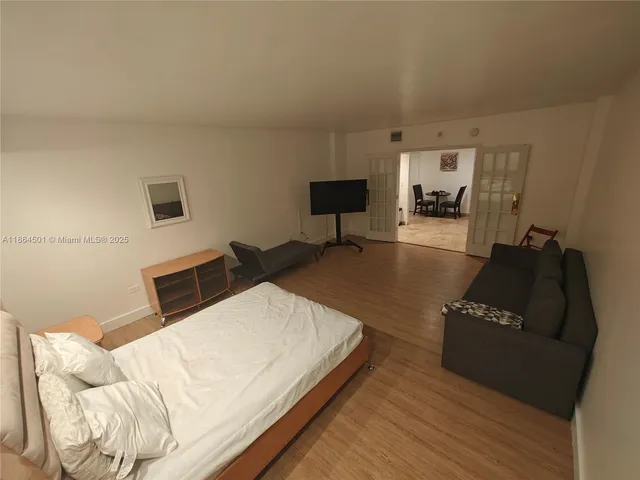 a bedroom with a bed a table and a chair