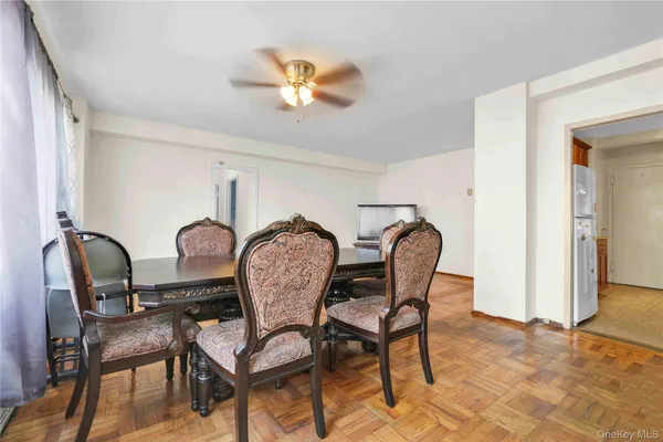 a dining room with furniture and chandelier