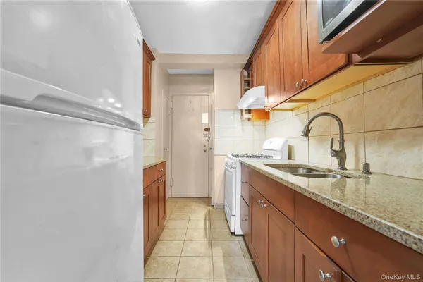 a kitchen with a sink and a refrigerator