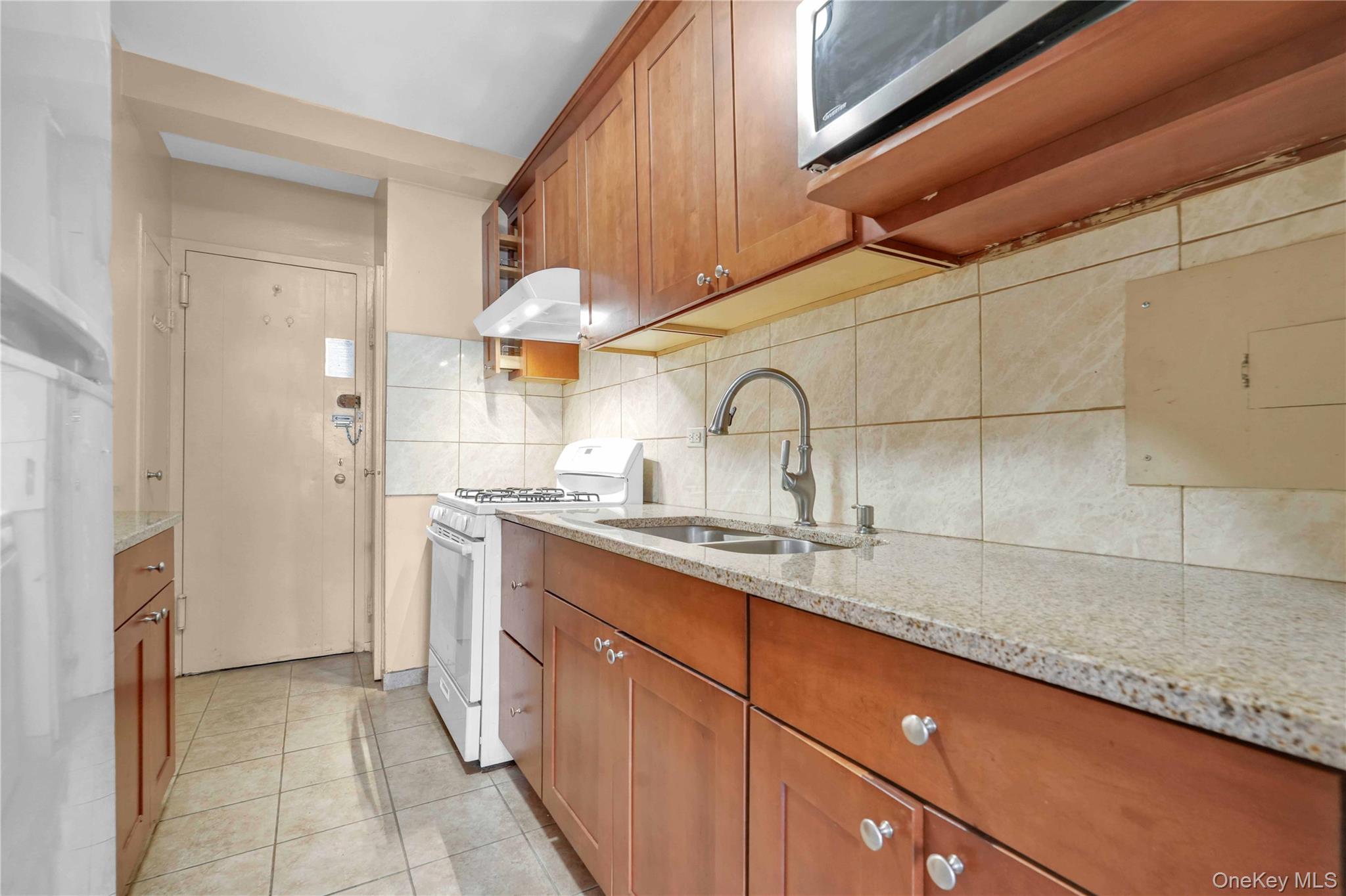 6 Fordham Hill Ovl, Unit 11G Bronx, NY 10468 - Photo 15 of 26 a kitchen with a sink and cabinets