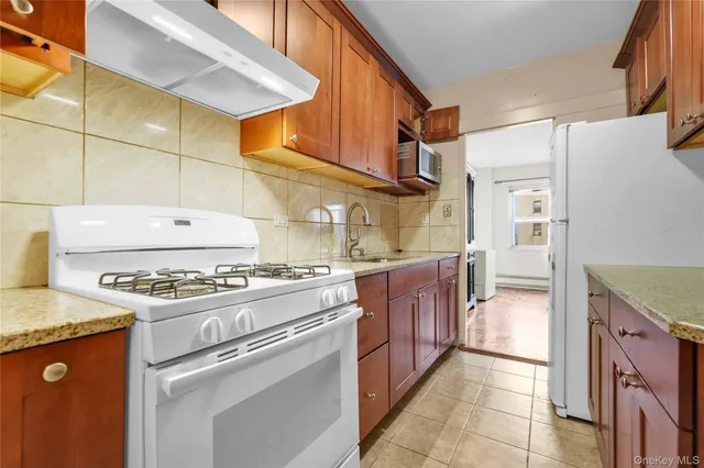 a kitchen with stainless steel appliances granite countertop a stove and a refrigerator