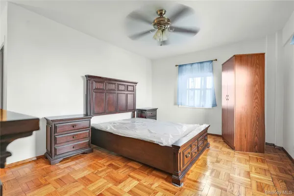 a spacious bedroom with a bed and a dresser