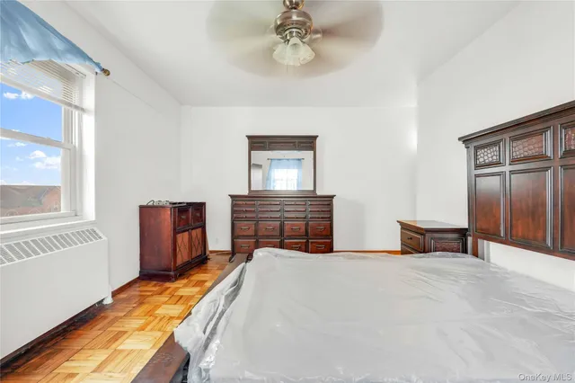 a bedroom with a bed and a chandelier