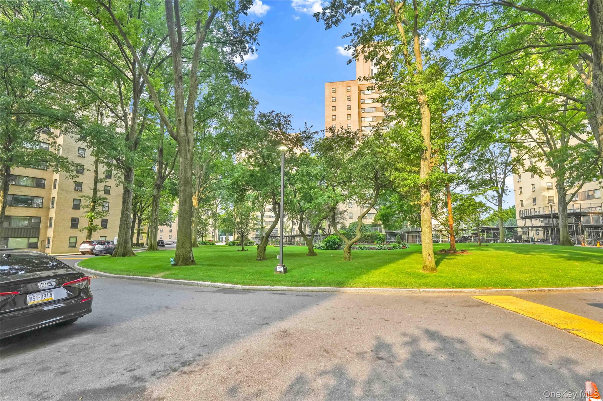 6 Fordham Hill Ovl, Unit 11G Bronx, NY 10468 - Photo 2 of 26 a view of a parked cars in front of a building