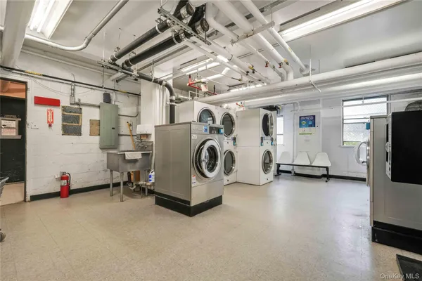 a view of a storage & utility room with two washing machine