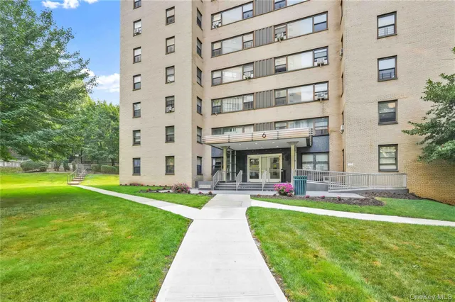 a front view of a building with a garden