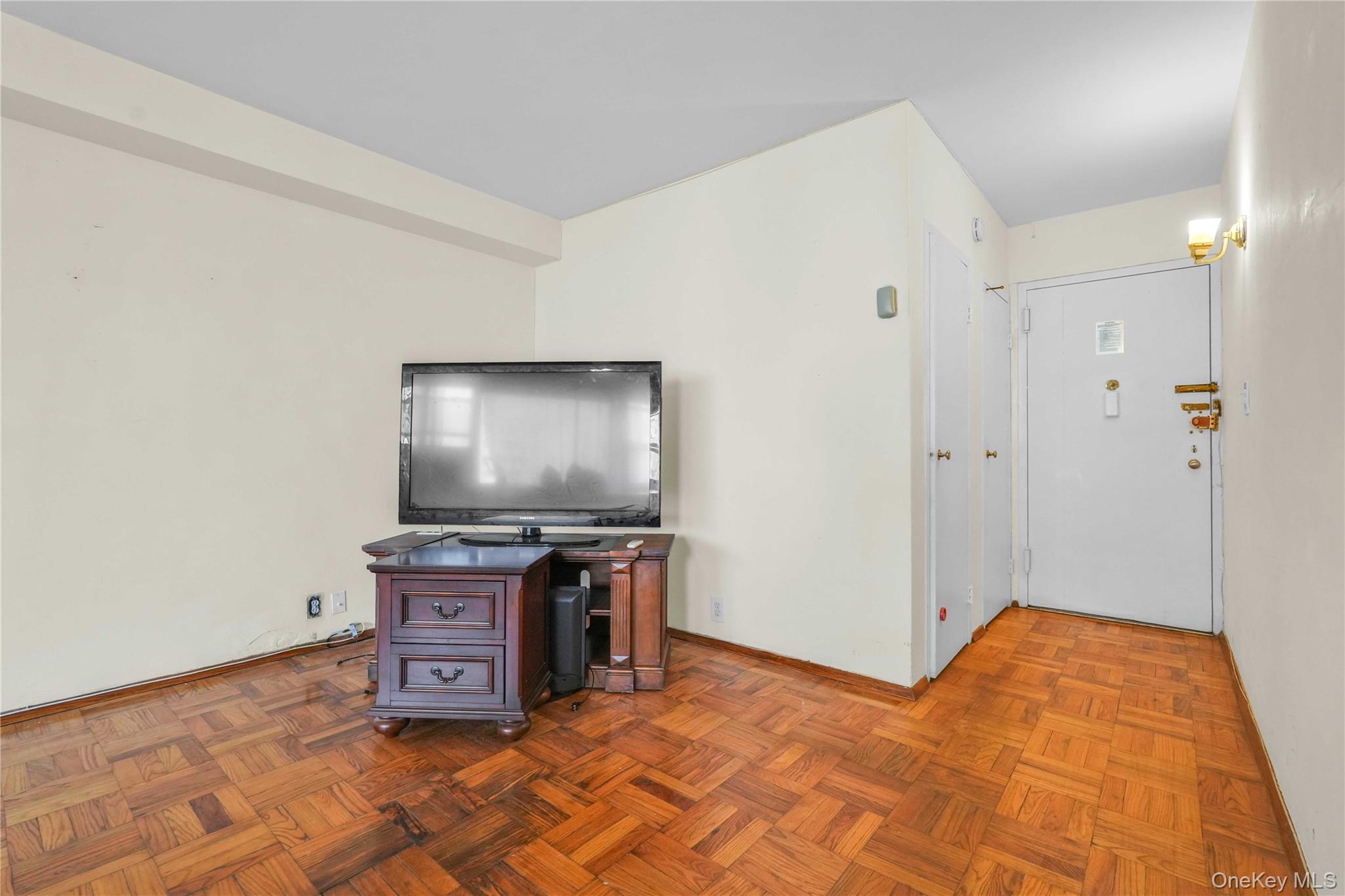 6 Fordham Hill Ovl, Unit 11G Bronx, NY 10468 - Photo 5 of 26 a bedroom with a bed and a flat screen tv