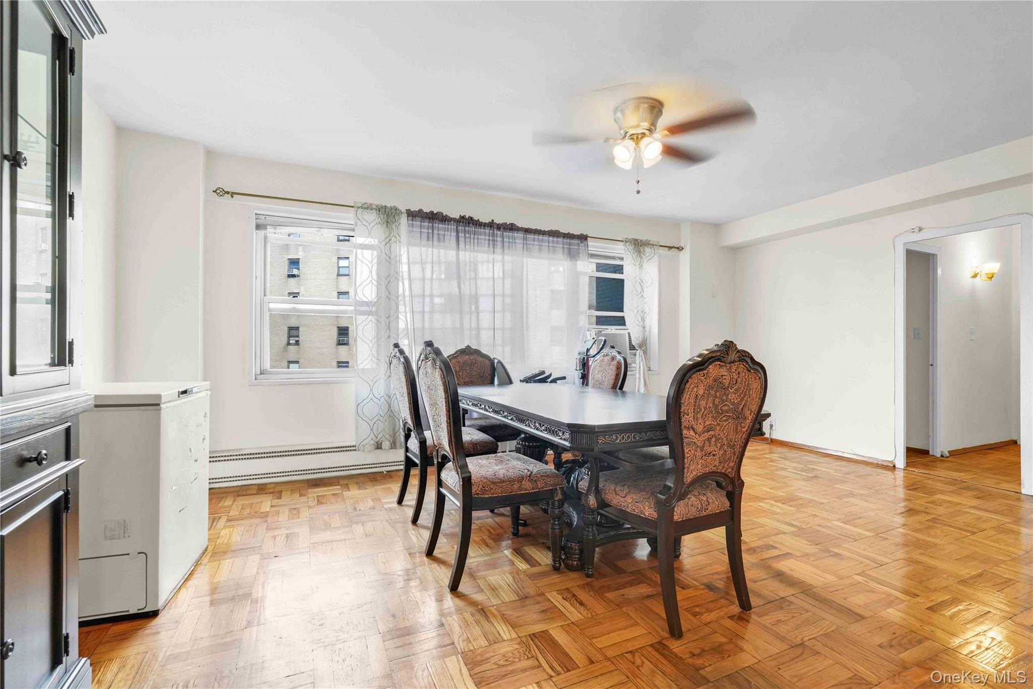 6 Fordham Hill Ovl, Unit 11G Bronx, NY 10468 - Photo 8 of 26 a view of a dining room with furniture and a chandelier