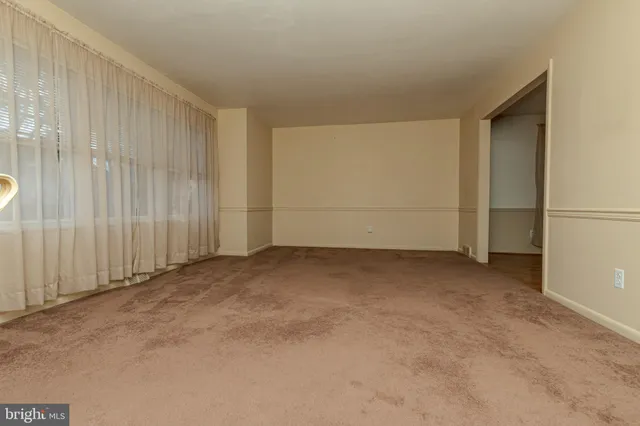 a view of empty room with fireplace