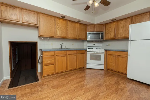 a kitchen with a sink a stove and cabinets