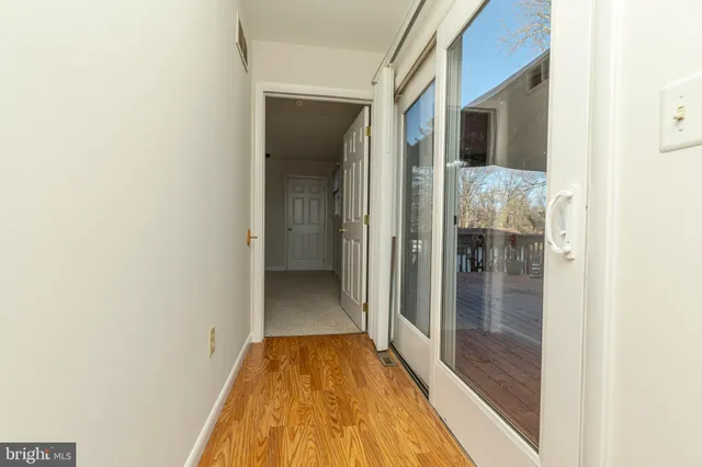 a view of empty room with chandelier fan