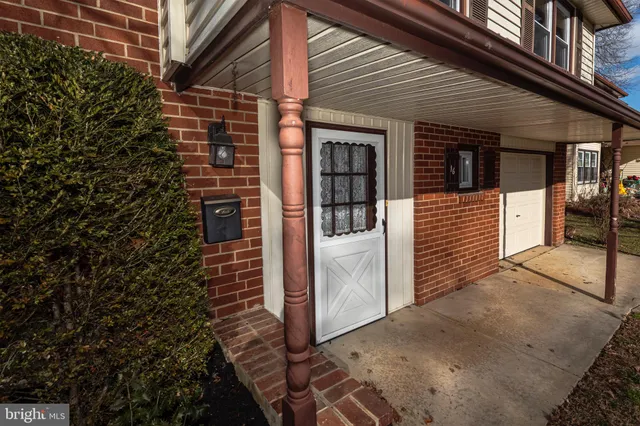 a view of a house with a door and wooden walls