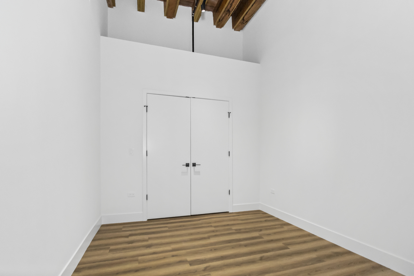 153 West Ohio Street, Unit 406 Chicago, IL 60654 - Photo 7 of 14 a view of a room with wooden floor