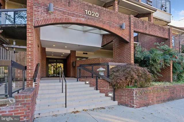 a front view of a building with glass windows and door