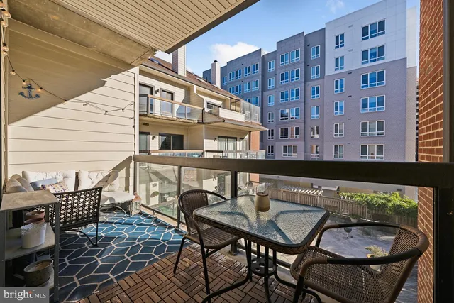 a view of a chairs and table in the balcony