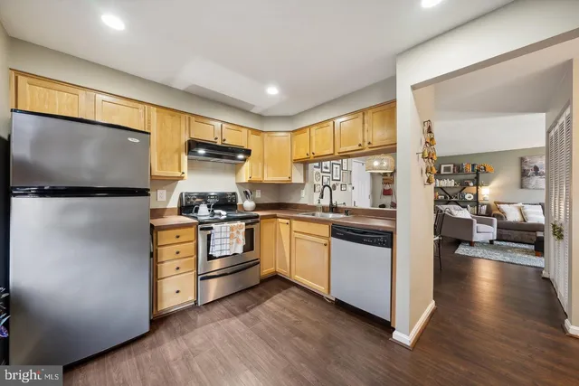 a kitchen with a stove a sink and a refrigerator