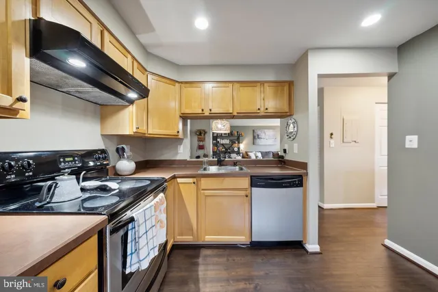 a kitchen with stainless steel appliances granite countertop a stove and a sink