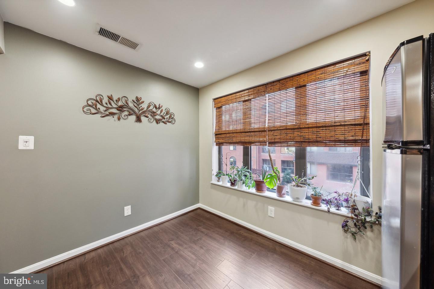 1020 North Stafford Street, Unit 311 Arlington, VA 22203 - Photo 25 of 37 an empty room with wooden floor and windows