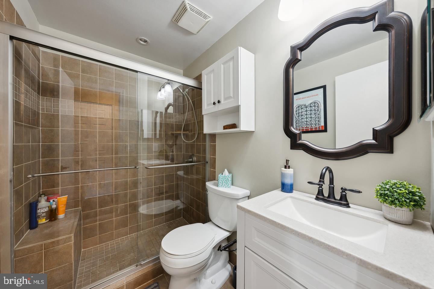 1020 North Stafford Street, Unit 311 Arlington, VA 22203 - Photo 28 of 37 a bathroom with a toilet sink and mirror