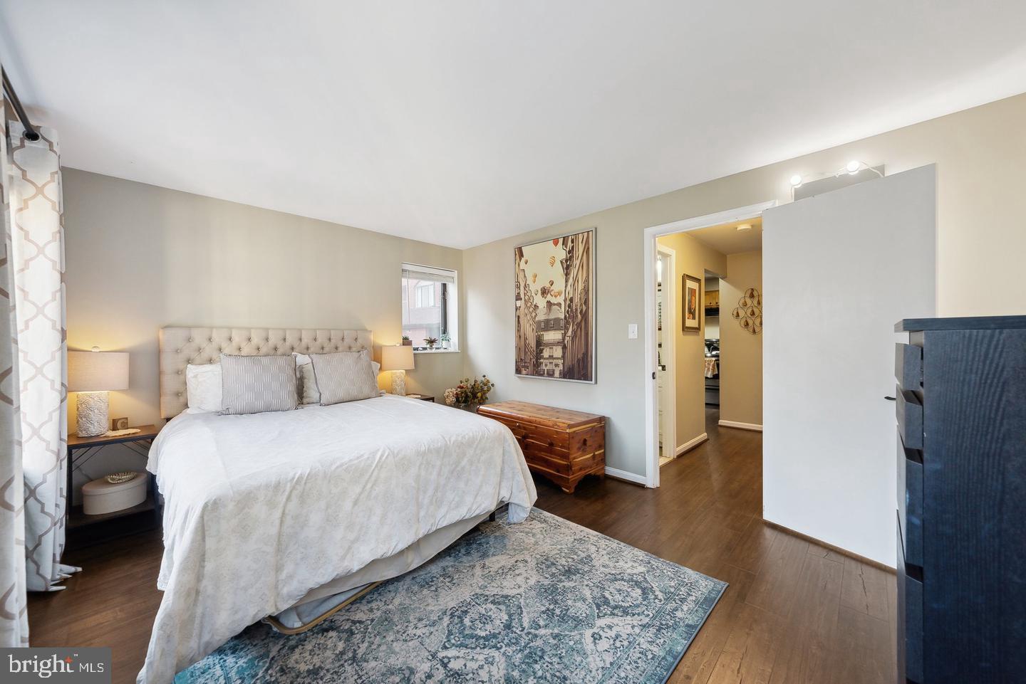1020 North Stafford Street, Unit 311 Arlington, VA 22203 - Photo 30 of 37 a spacious bedroom with a bed and wooden floor