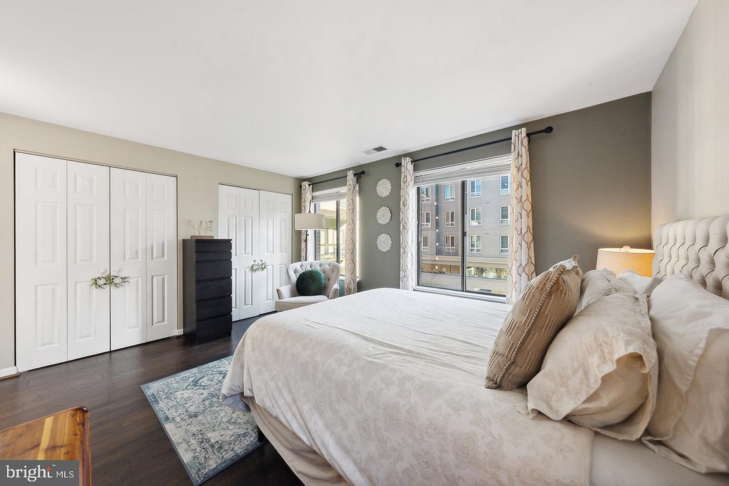 1020 North Stafford Street, Unit 311 Arlington, VA 22203 - Photo 31 of 37 a spacious bedroom with a bed and glass window