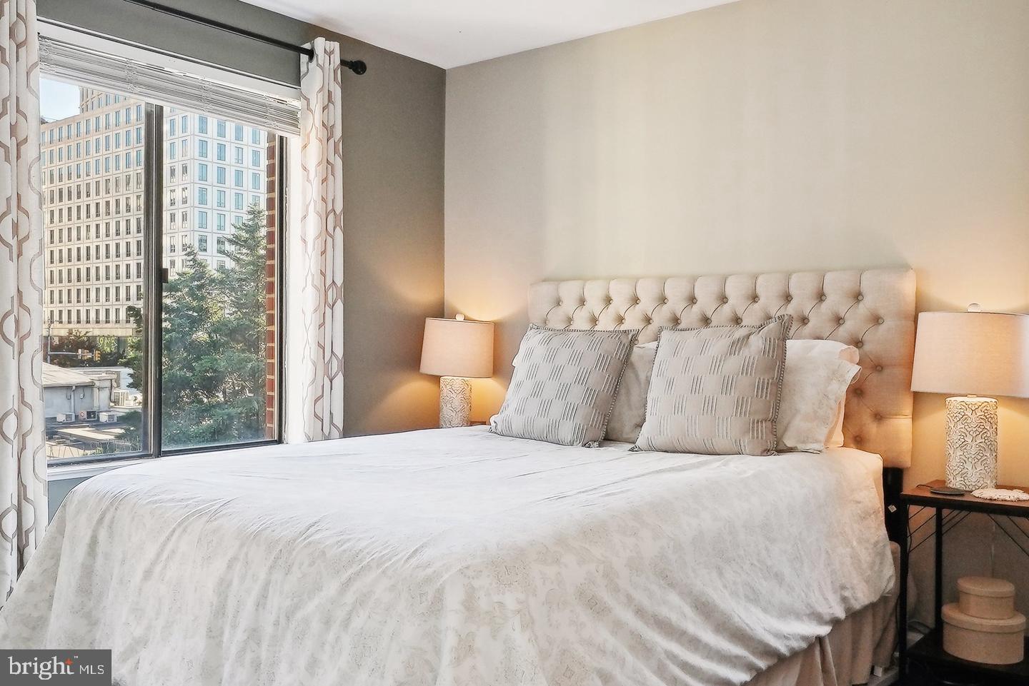 1020 North Stafford Street, Unit 311 Arlington, VA 22203 - Photo 33 of 37 a large bed sitting in a bedroom next to a window