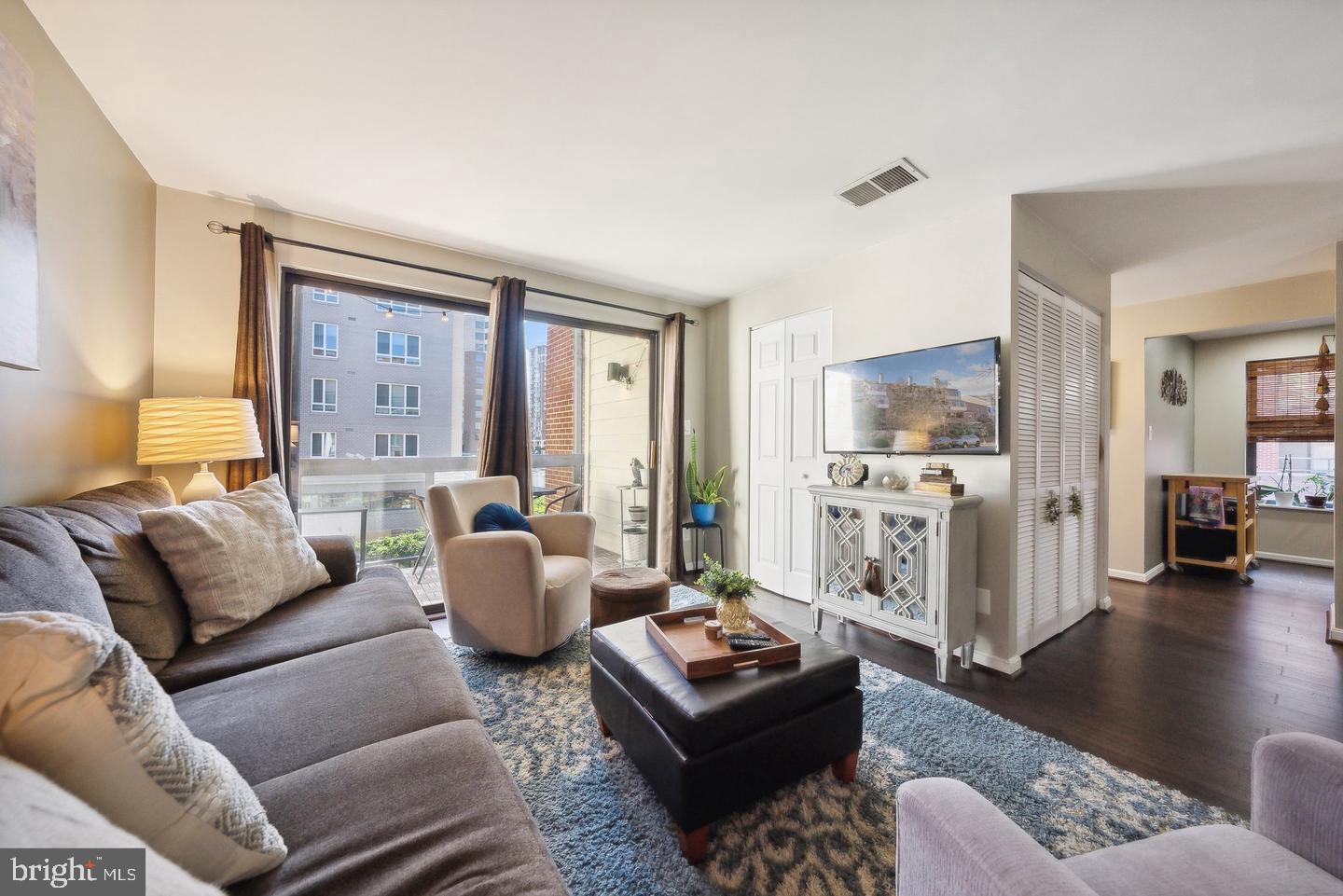 1020 North Stafford Street, Unit 311 Arlington, VA 22203 - Photo 7 of 37 a living room with furniture and a wooden floor