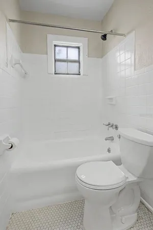 a bathroom with a toilet and a bathtub