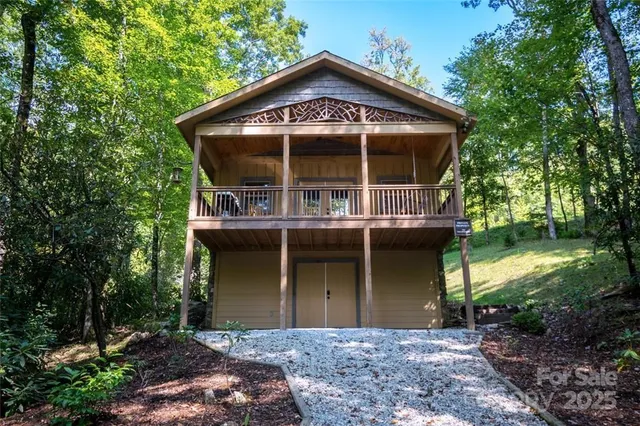 a front view of a house with a garden and plants
