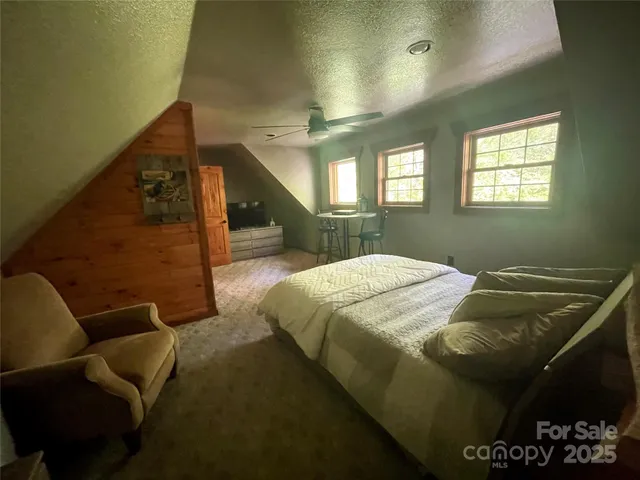 a bed sitting in a bedroom next to a window