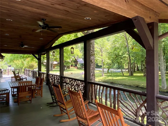 a view of a porch with furniture and backyard