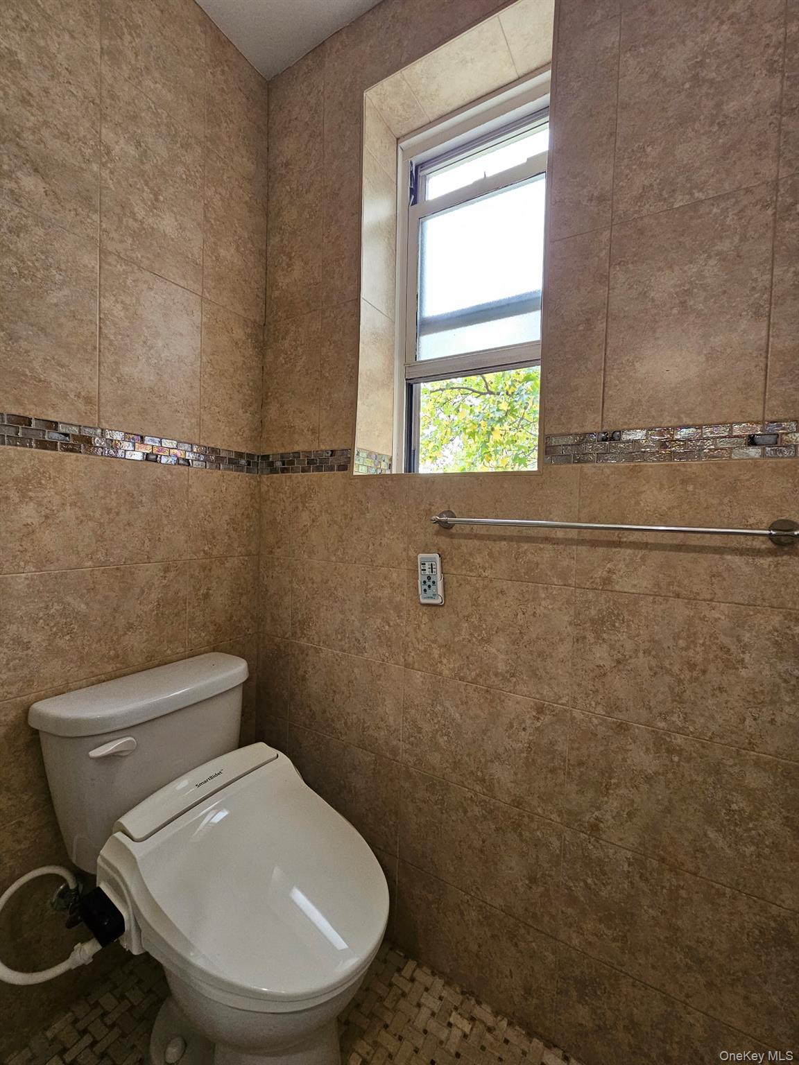 18-50 211th Street, Unit 3D Queens, NY 11360 - Photo 4 of 9 a white toilet sitting next to a window