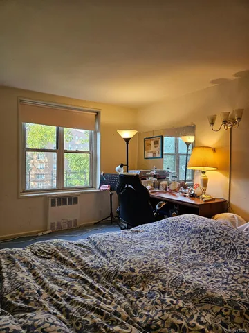 a bed room with a bed window and dresser