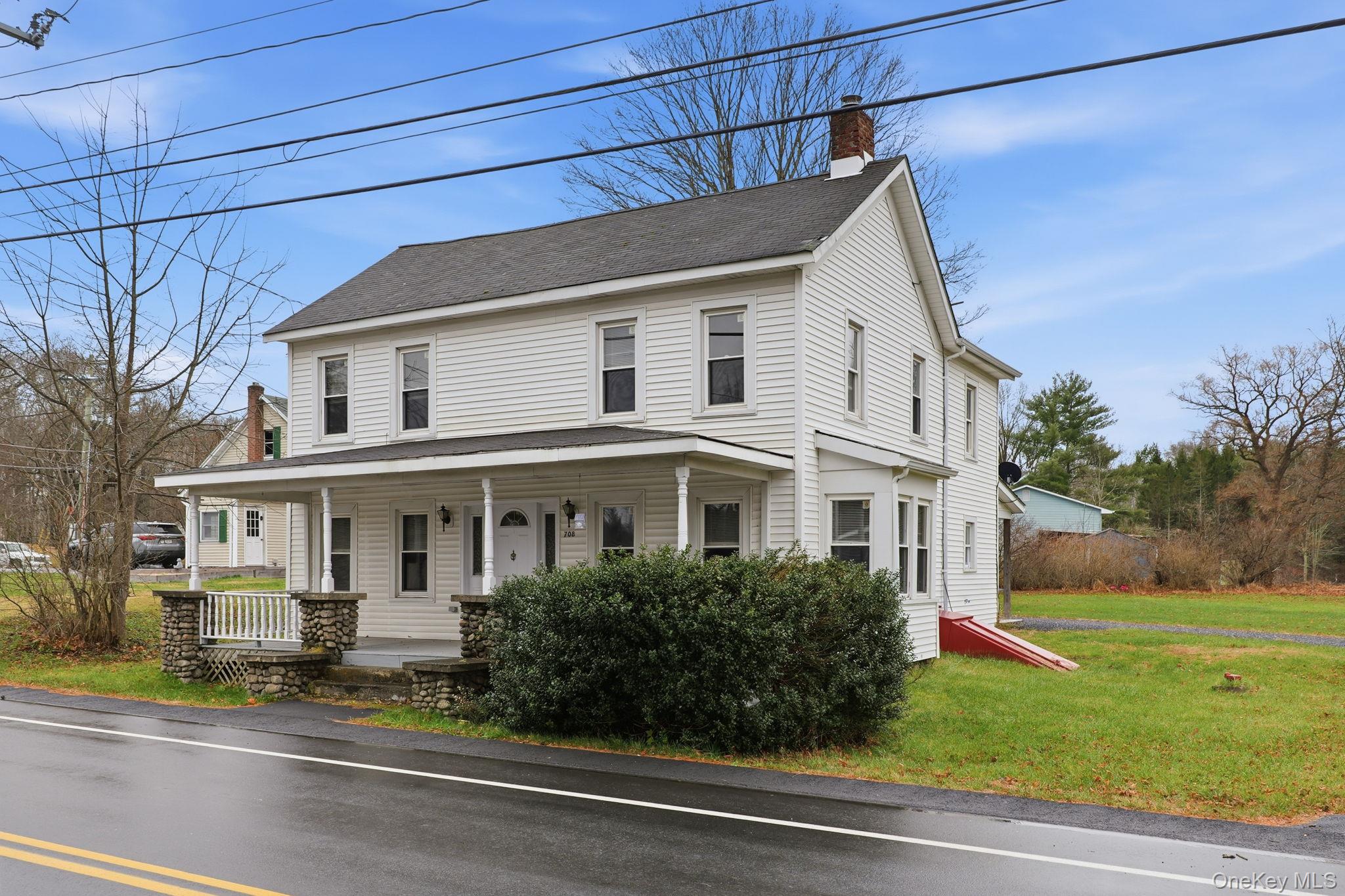 708 Burlingham Road Bloomingburg, NY 12721 - Photo 2 of 25 View of front of house with a porch, a front lawn, a chimney, and roof with shingles