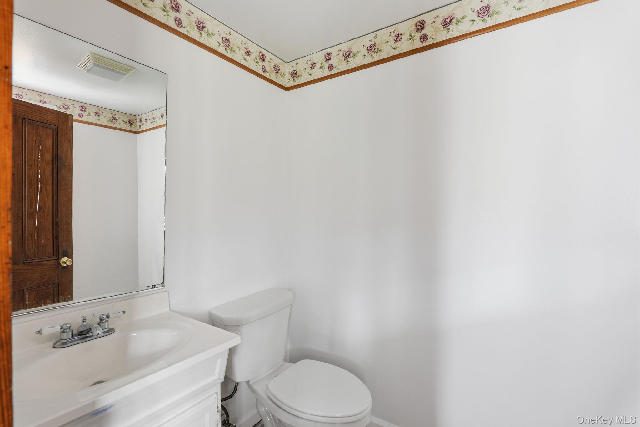 708 Burlingham Road Bloomingburg, NY 12721 - Photo 21 of 25 Half bath with vanity and toilet