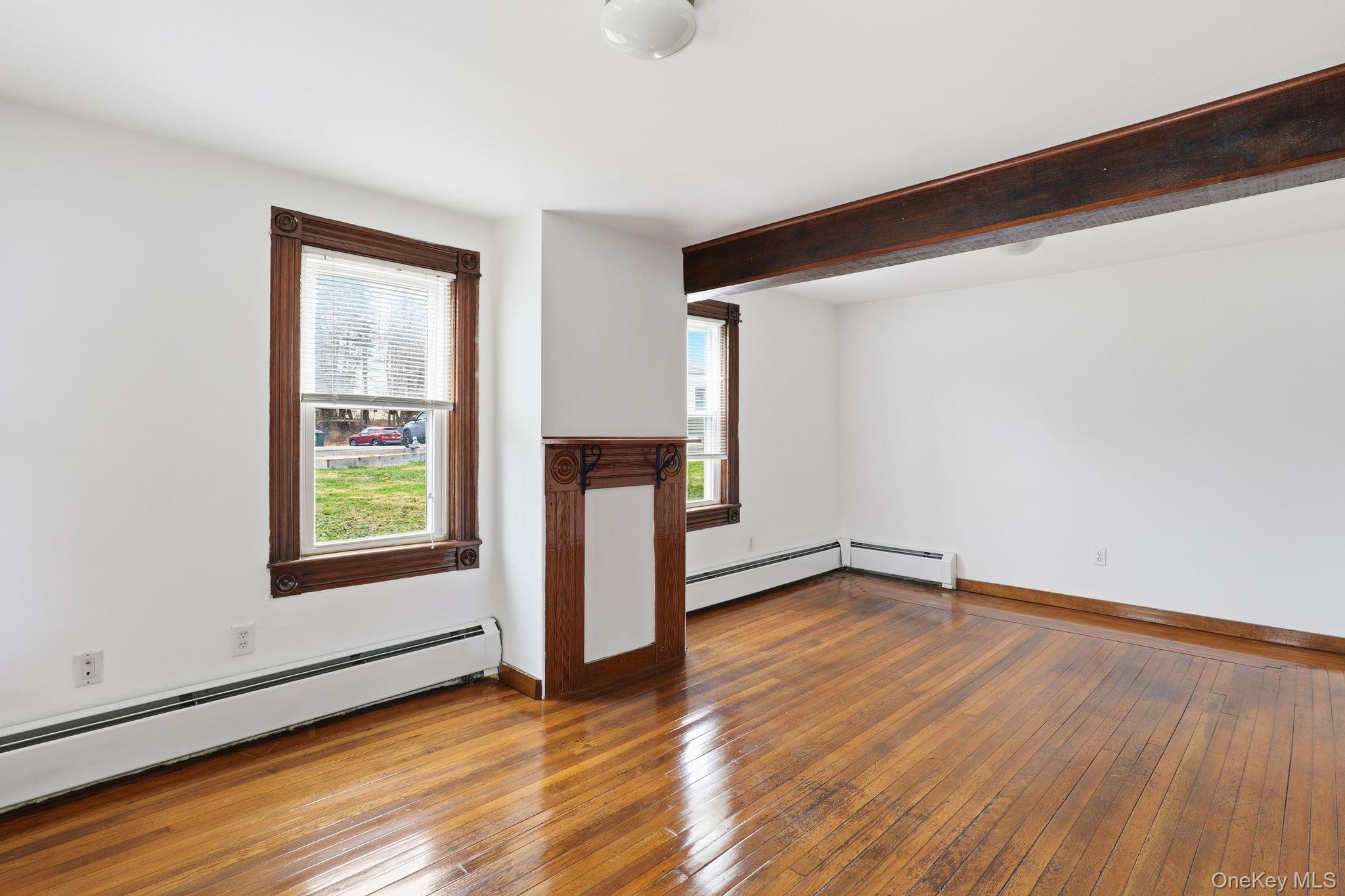 708 Burlingham Road Bloomingburg, NY 12721 - Photo 5 of 25 Spare room with plenty of natural light, a baseboard heating unit, hardwood / wood-style floors, and beamed ceiling