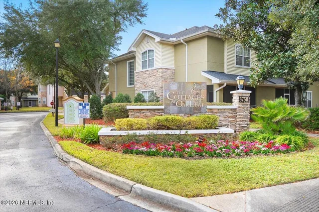 a front view of a house with a yard and fountain