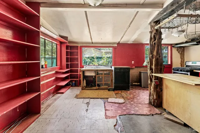a living room with furniture a flat screen tv and floor to ceiling window