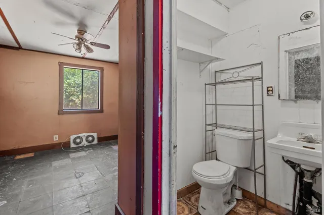 a bathroom with a toilet and a shower
